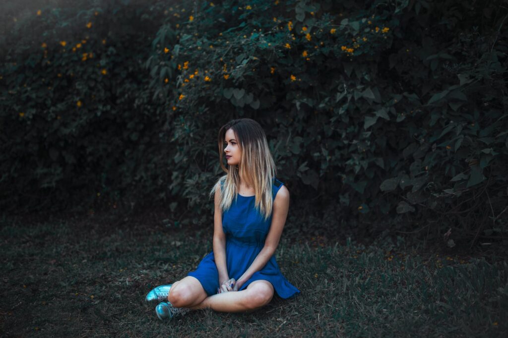 woman sitting on grass field