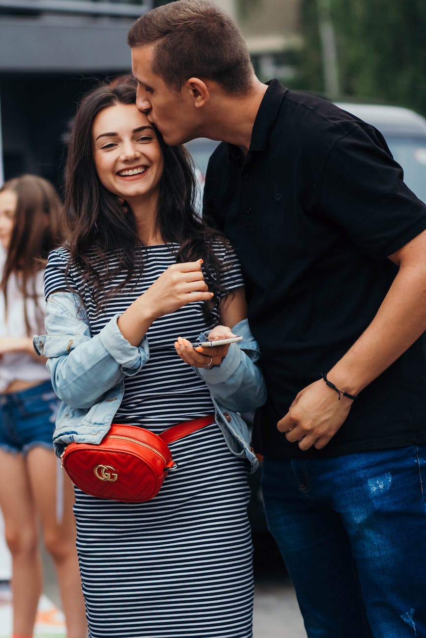 photo of man kissing woman s forehead