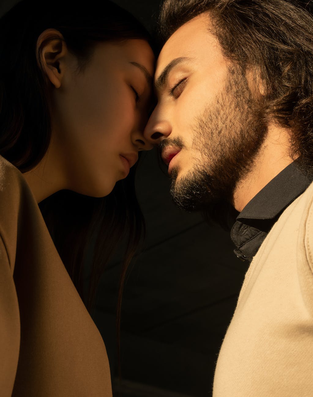 man and woman closing their eyes
