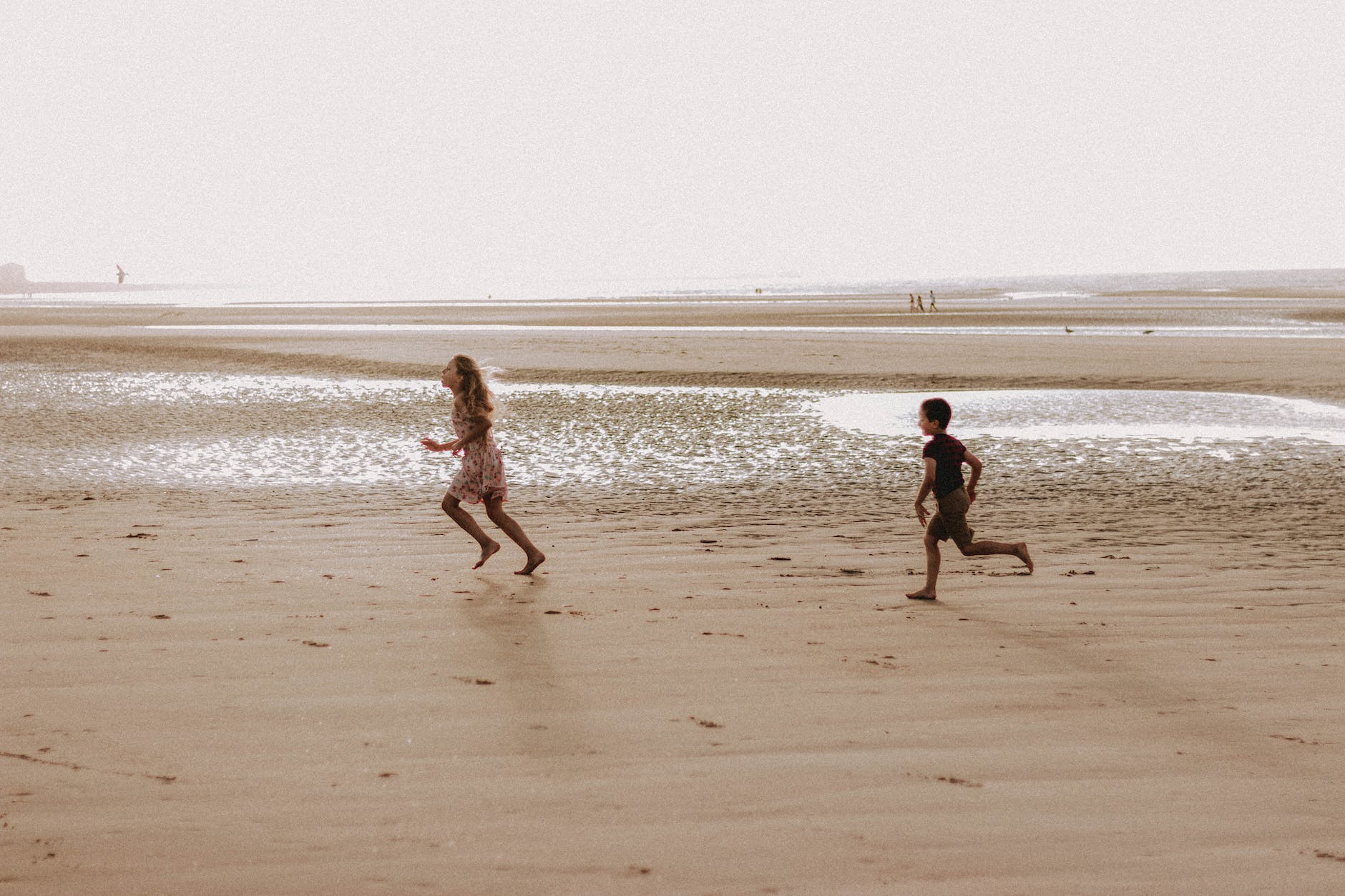 kids running on sandy beach