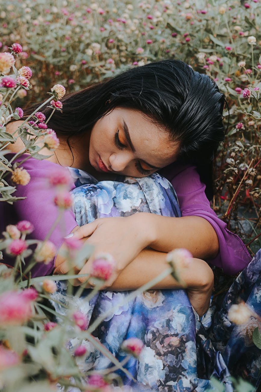woman sits on the flower field